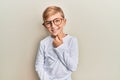 Little caucasian boy kid wearing casual clothes and glasses smiling looking confident at the camera with crossed arms and hand on Royalty Free Stock Photo