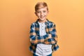 Little caucasian boy kid wearing casual clothes happy face smiling with crossed arms looking at the camera Royalty Free Stock Photo