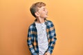 Little caucasian boy kid wearing casual clothes looking away to side with smile on face, natural expression Royalty Free Stock Photo