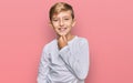 Little caucasian boy kid wearing casual clothes looking confident at the camera with smile with crossed arms and hand raised on Royalty Free Stock Photo