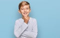 Little caucasian boy kid wearing casual clothes looking confident at the camera smiling with crossed arms and hand raised on chin Royalty Free Stock Photo