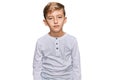 Little caucasian boy kid wearing casual clothes relaxed with serious expression on face Royalty Free Stock Photo