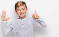 Little caucasian boy kid wearing casual clothes showing and pointing up with fingers number six while smiling confident and happy Royalty Free Stock Photo