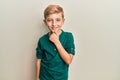 Little caucasian boy kid wearing casual clothes smiling looking confident at the camera with crossed arms and hand on chin Royalty Free Stock Photo
