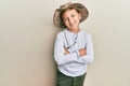 Little caucasian boy kid wearing explorer hat happy face smiling with crossed arms looking at the camera Royalty Free Stock Photo
