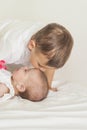 Little Caucasian Boy Kissing His Newborn Sister. Indoors Shot.