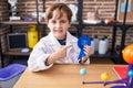 Little caucasian boy at school scientist laboratory winning first prize smiling happy pointing with hand and finger