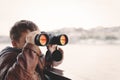 Little boy watching, looking, gazing, searching for by binocular