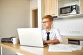 Little caucasian boy work on laptop at home Royalty Free Stock Photo