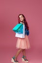 little caucasian child girl holds shopping bags Royalty Free Stock Photo