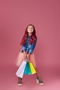 little caucasian child girl holds shopping bags Royalty Free Stock Photo