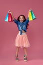 little caucasian child girl holds shopping bags Royalty Free Stock Photo