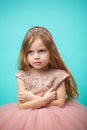 Little Caucasian female child in pink dress with naughty and res