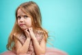 Little Caucasian female child in pink dress with naughty and resentful face expression. Royalty Free Stock Photo