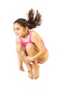 Little caucasian female 8 years old girl in pink swimmwear jumping on white background. Royalty Free Stock Photo