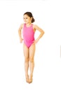 Little caucasian female 8 years old girl in pink swimmwear jumping on white background. Royalty Free Stock Photo