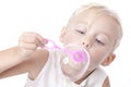 Little caucasian girl blowing soap bubbles