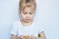 Little Caucasian girl child learns to sew colorful buttons. Royalty Free Stock Photo