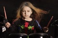 Little caucasian girl drummer with multicolored hair playing the electronic drum kit Royalty Free Stock Photo