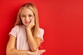 Little caucasian girl has toothache, isolated on red background