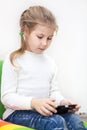 Little Caucasian girl has unlimited net access. Internet usage with smartphone