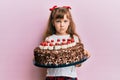 Little caucasian girl kid celebrating birthday holding big chocolate cake depressed and worry for distress, crying angry and Royalty Free Stock Photo