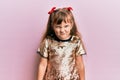 Little caucasian girl kid wearing festive sequins dress skeptic and nervous, frowning upset because of problem Royalty Free Stock Photo