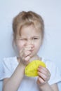 Little Caucasian girl learns to insert a thread into a needle. Royalty Free Stock Photo