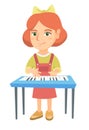 Little caucasian girl playing the piano. Royalty Free Stock Photo