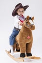 Little Caucasian Girl Posing in Cowgirl Clothing with Toy Horse