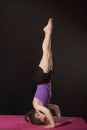 Little caucasian girl practing headstand pose Royalty Free Stock Photo