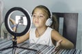 Little caucasian girl recording a video tutorial