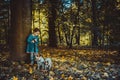 Little caucasian girl running around the autumn park with the dogs. Royalty Free Stock Photo