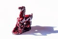 Little ceramic statues of symbolic animals on white background, Horse sculpture.