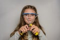 Little charming baby girl in safety glasses with two screwdrivers Royalty Free Stock Photo