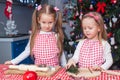 Little charming sisters bake gingerbread cookies Royalty Free Stock Photo