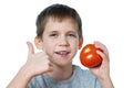 Little cheerful boy with tomato showing thumbs up isolated Royalty Free Stock Photo