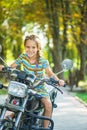 Little cheerful girl on old bike