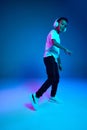 Little cheerful happy boy 6-7 years old wearing white t-shirt and headphones listen to music isolated on blue background Royalty Free Stock Photo