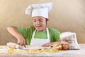 Little chef cutting the dough making pasta Royalty Free Stock Photo