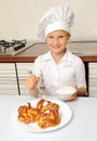 Little chef decorating cakes