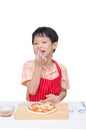 Little chef eating crab between cooking pizza Royalty Free Stock Photo