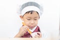 A little chef is eating yogurt Royalty Free Stock Photo