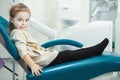 Little child sits in comfortable leather dentist chair Royalty Free Stock Photo