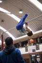 Little child athletic gymnast performing exercises at the bar in the championship Royalty Free Stock Photo