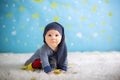 Little baby boy with cute teddy bear and moon on a blue star and Royalty Free Stock Photo