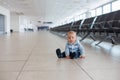 Little child, baby boy, playing at the airport, while waiting for his plane to departure