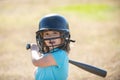 Little child baseball player focused ready to bat. Kid holding a baseball bat. Royalty Free Stock Photo