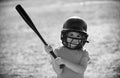 Little child baseball player focused ready to bat. Kid holding a baseball bat. Royalty Free Stock Photo