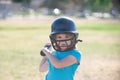 Little child baseball player focused ready to bat. Sporty kid players in helmet and baseball bat in action. Royalty Free Stock Photo